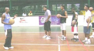 Okay, this is what I want you to do! National Coach Robert Cadogan (extreme left) explaining what he wants from the young players at yesterday’s IGG team practice. 