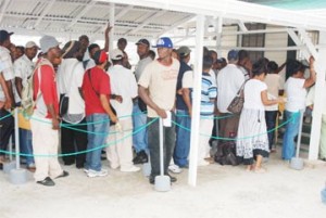 Some of the persons gathered in the compound of the Guyana Revenue Authority License Office at Smyth and Princes Street yesterday, while a blackout disrupted service. (See story on Page 3) (Photo by Jules Gibson) 