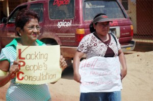 Is anyone listening: Two protesters in front of the Lethem Power Company yesterday. (Photo by Liana Forever) 