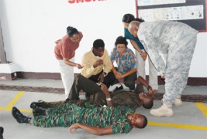 Personnel from the GDF and US military attend to two `casualties’ during a simulated practical demonstration. 