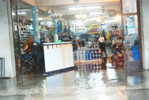 Heavy rainfall yesterday saw most of the city and its environs inundated. In this photo water enters Guyana Stores Hardware Division on Water Street. (Photo by Jules Gibson)