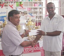 Managing Director of Mike’s Pharmacy Lakhram Singh (left) hands over the sponsorship cheque to vice-chairman of  GSL Halim Khan (right).   