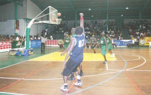 On the money!  Andrew Ifill hits home a three-point jumper over Clement Brushe during the second half of their finals on Sunday at the Cliff Anderson Sports Hall. (Orlando Charles photo) 
