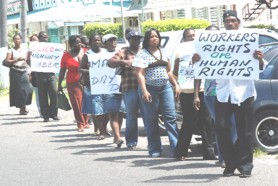 Former employees of Premium Security Services protesting outside the CLICO Head Office.