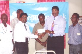 Republic Bank’s New Amsterdam Branch Manager Imran Sacoor (left) hands over the sponsorship cheque to BCBC Treasurer Anil Beharry.  
