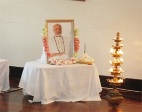 A portrait of the late Pandit Prakash Gossai garlanded with flowers during a tribute to him at the Indian Cultural Centre yesterday. 