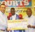 Courts Guyana Inc. Country Manager Lester Alvis (left) hands over their sponsor’s cheque to promoter Stanford Solomon (right) while Leon ‘The Lion’ Gilkes poses in the centre (Orlando Charles photo).