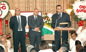 Standing from left at the last rites in New York for Pandit Prakash Gossai are Commerce Minister Manniram Prashad, IAST Director Dr Suresh Narine and Agriculture Minister Robert Persaud. (See story on centre pages)