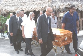 Pall bearers carrying the coffin after yesterday’s funeral service at the Umana Yana.  The pall bearers were Yuri Chandisingh (left foreground) and Alan Munroe (right foreground),   Navin Chanderpal (behind Chandisingh), Cheryl Sampson (behind Munroe), Speaker of the National Assembly, Ralph Ramkarran (behind Chanderpal) and Winston Murray (behind Sampson). (Photo by Jules Gibson)