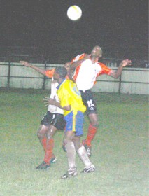 Two Camptown players (black trunks) double bank a Pele player (yellow) in their match up on Friday at the Tucville Playfield. (Orlando Charles Photo) 