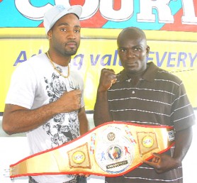 Who will be the executioner? Lennox Allen (left) and Leon Gilkes pose with the National Super Middleweight title belt. (Orlando Charles photo)  