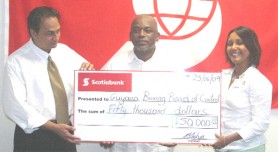 Scotia Bank’s Production and Marketing Manager Jennifer Cipriani-Nelson (right) hands over her company’s cheque  to promoter Stanford Solomon (center) and GBBC President Peter Abdool. (Orlando Charles photo)