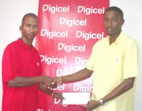 Welcome aboard! Digicel’s sponsorship and events executive Sherwin Campbell (left) makes a presentation to NLE Director Travis Shepherd (Orlando Charles photo). 