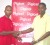 Welcome aboard! Digicel’s sponsorship and events executive Sherwin Campbell (left) makes a presentation to NLE Director Travis Shepherd (Orlando Charles photo). 