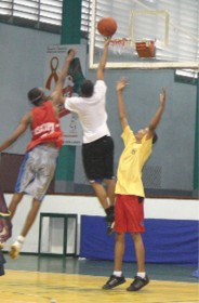 Hugh Arthur (centre) scores yet another basket for Natural Sciences at yesterday’s Inter-faculty Basketball Finals at the Cliff Anderson Sports Hall.