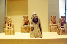 When one thinks of international chess, it is unlikely that one would think of Scotland. Yet chess there boasts a lengthy history which dates back to mediaeval times. The Lewis chessmen, the oldest in Europe, and perhaps the oldest in the world, were found near Uig on Lewis in the early 19th century. The origin of the pieces is unknown, but scholars believe they were made in Norway around 1200 and were intended for use in Ireland. Today, some of the pieces (in photo) are on display at the National Museum in Scotland, and the remainder (the majority) in the British Museum. From time to time, grandmasters and chess players alike, visit one or other museum to have a look, and especially to examine the fine craftsmanship of the pieces.