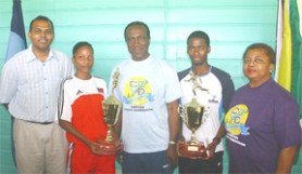 CHAMPIONS DELIGHT! Minister of Culture, Youth and Sports, Dr. Frank Anthony (L) poses with male and female winners Cleveland Forde and Christine Rajis along with Caricom Secretary General Dr. Edwin Carrington and Deputy Secretary General Lolita Applewaithe (Orlando Charles Photo) 