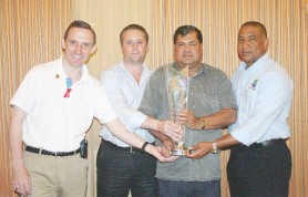 Touching the ‘Holy Grail’: from left to right; Media and Communication Manager Brian Murgatroyd, ICC’s events manager Chris Tetley, President of the Guyana Cricket Board Chetram Singh and WICB ICC 2010 Twenty20 World Cup Tournament Director Ernest Hillaire, touching the ICC Twenty20 World Cup Trophy (Orlando Charles Photo)   