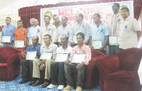 Minister of Agriculture, Robert Persaud (sixth from left, standing) and some members of GuySuCo’s board pose with the champion workers.