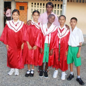 Teacher of Lachmansingh Primary School Constance Mc Calmont with the five top students. From left to right are: Chandini Singh, Bhawani Ramdeo, Ivor Franklin, Kareem Bacchus and Sudesh Jaipersaud. 