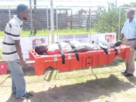 Two University of Guyana students demonstrate the use of the Relief Pod. 