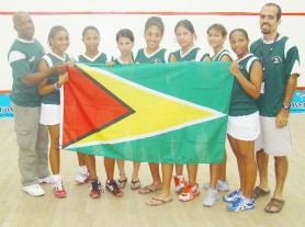 WE ARE THE CHAMPIONS! The victorious Guyana junior squash girl’s team. Coach Carl Ince is at left and manager Robert Fernandes extreme right. 