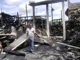 Minister of Health Dr Leslie Ramsammy stands amid the ruins of the ministry. 
