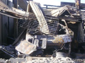 Zinc sheets lie on one of the minibuses which was destroyed by the fire