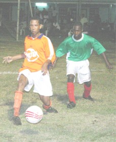 A BV player in this Orlando Charles photo looks to challenge a player from Fruta Conquerors at the Plaisance Community Centre ground in the East Coast Football Union tournament.