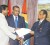 WIPA President Dinanath Ramnarine (left) and Dr Julian Hunte, WICB Presi-dent, shake hands to signify the completion of the agreement between the two parties, as CARICOM Chairman, President Bharrat Jagdeo looks on. (Office of the President photo) 