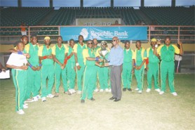 Captain of Jamaica’s Blind Cricket Team Toussaint Gardner receives the championship trophy from president of the West Indies Blind Cricket Council Clevdon Mayers. (Orlando Charles photo)