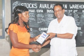 FRUITFUL PARTNERSHIP! Fruta Conquerors  Treasurer Candia Shepherd (left) presents a plaque of appreciation to Guyana Beverage Inc. Managing Director Robert Selman (right) for the company’s continued support to their club. 