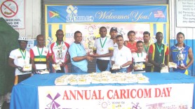 Chief Executive Officer of NAMILCO Bert Sukhai (fourth from left) presents the winning trophy to Warren McKay while Auto Lakeram (NAMILCO Finance Controller) and Brian Allen President of Roraima Bikers Club pose with other prize winners. 