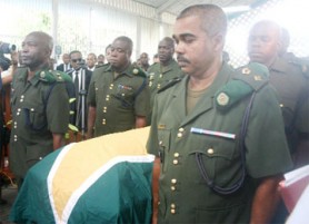 Officers of the GDF bearing the casket of Retired Colonel Godwin McPherson at yesterday’s funeral service. (Orlando Charles photo)   