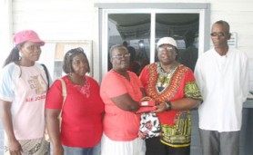 Yvonne Jackson (second from right) makes the donation to Sonia Hinds. Also in the photo (from left to right) are Pamela Caesar (member of Troopers of Charity), Carolyn Weekes (sister of Hinds) and Kenneth Johnson. 
