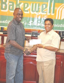 Kashif and Shanghai Co-Director Aubrey ‘Shanghai’ Major (left) is all smiles while collecting the sponsorship cheque from Bakewell’s General Manager Rajin Ganga.   