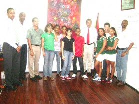 Executive members of the Squash board along with eight members of the junior squash team which paid a visit to the Minister of Culture, Youth and Sport (Rawle Toney photo) 
