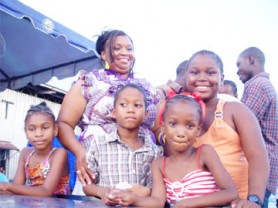 Malika Boyd’s children Anneisha, 11 (right), Alicia, 6, (front) and Antonio, 8 (left) share a proud moment with her. 