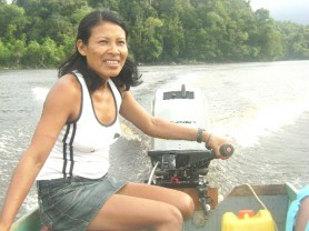 Isseneru resident Ceila Joseph operates the outboard engine of a speedboat along the Mazaruni River. 
