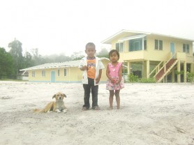  Two children of Isseneru pose for a photograph  with their dog.  