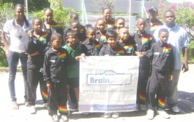 Brain Street Learning representatives Trulesha Barry, (left) and Jason Joseph (right) pose with the Junior Table Tennis team for this year’s Pre-Cadet Tournament in Barbados. (Rawle Toney photo)      