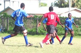 Part of Sunday afternoon’s action between Tutorial Academy and Diamond Elvin Secondary School at Scote Primary School ground in New Amsterdam.