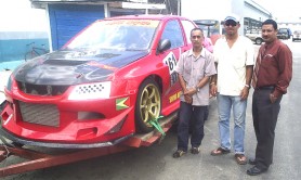 Kevin Jeffery (centre) and his chief mechanic Brian Ten-Pow (right) along with Vice President of the GMR&SC Peter Peroune at John Fernandes wharf prior to shipping his car to  Barbados for the second round of the Caribbean Motor Racing Championship. (Rawle Toney photo)  