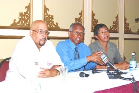Team Murray? Candidate for PNCR leader Winston Murray (centre) addressing reporters during a news conference yesterday at the Pegasus Hotel. At left is Dr Richard Van West-Charles, who announced his withdrawal from the race for leader yesterday. Also in photo is Reform co-founder Stanley Ming, who said he and former members are willing to return to work with Murray. (Jules Gibson photo)   