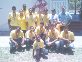 The swimming team that represented Guyana at the Goodwill Swimming Championships get together for a group photograph at Colgrain Swimming Pool with the medals won in Barbados, the host nation. 