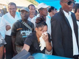 Ramdass’ sister-in-law breaks down in tears as she looks at the coffin carrying his body. 