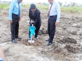 Minister of Finance Dr. Ashni Singh (centre) performs the symbolic turning of the soil. Managing Director of Republic Bank (Guyana) Limited Edwin Gooding is at right. Also in photo is Central Bank Governor Lawrence Williams. (Photo by Femi Harris)  