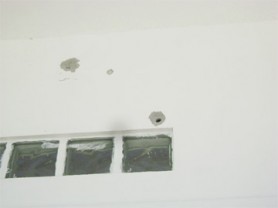 Bullet holes on the wall of a house close to where the shooting took place on Savage Street.  