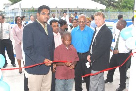 From left: Housing and Water Minister Irfaan Ali, Tucville resident Clevon McEwan, CEO GWI Yuri Chandisingh and IDB  country representative Marco Nicola as they cut the ribbon to mark the official opening of the $87M Tucville Sewerage Receiving Station.