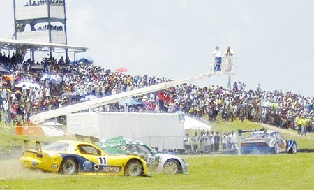 Oops! Guyana’s Andrew King and Stuart Williams both lost control and ran off the track on Sunday at the Bushy Park Circuit in Barbados. (Rawle Toney photo)    